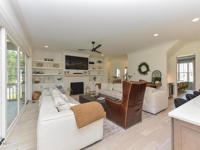 3666 Jordan Estates Way, New Hill, NC 27562 - living area with light wood-style floors, ceiling fan, ornamental molding, a fireplace, and recessed lighting