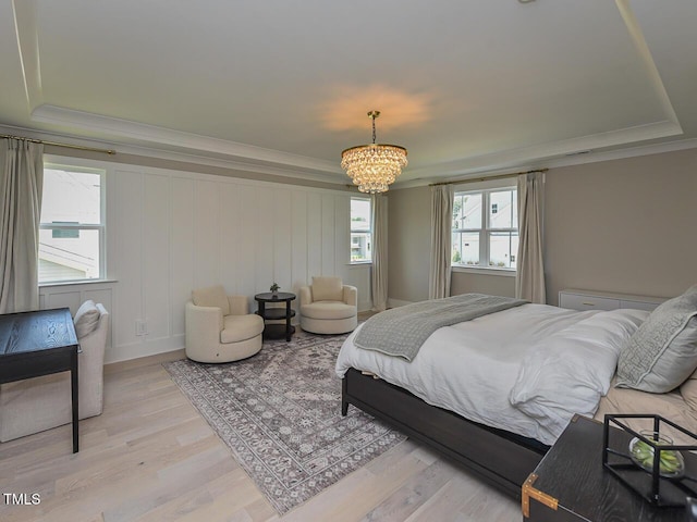 3666 Jordan Estates Way, New Hill, NC 27562 - bedroom with a chandelier, crown molding, light wood-type flooring, and a raised ceiling
