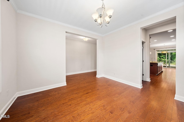 316 Rapport Dr, Cary, NC 27519 - empty room featuring a chandelier, wood finished floors, and ornamental molding