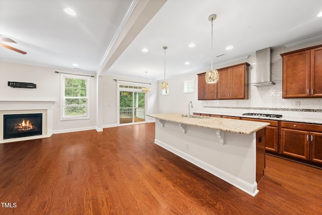316 Rapport Dr, Cary, NC 27519 - kitchen featuring wall chimney exhaust hood, open floor plan, a kitchen bar, light stone counters, and ceiling fan