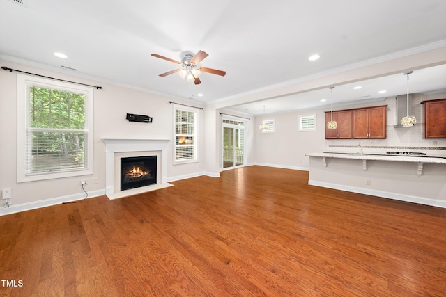 316 Rapport Dr, Cary, NC 27519 - unfurnished living room featuring ceiling fan, ornamental molding, a fireplace with flush hearth, dark wood-style flooring, and recessed lighting