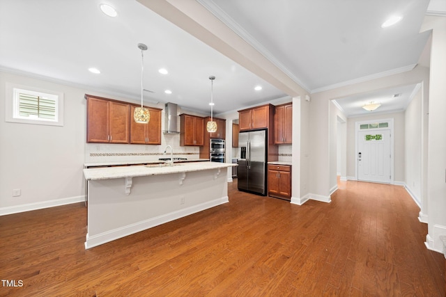 316 Rapport Dr, Cary, NC 27519 - kitchen featuring appliances with stainless steel finishes, wall chimney range hood, tasteful backsplash, ornamental molding, and a kitchen island with sink