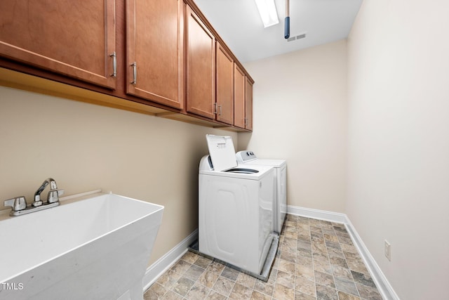 316 Rapport Dr, Cary, NC 27519 - laundry room featuring washer and dryer, cabinet space, and stone finish flooring