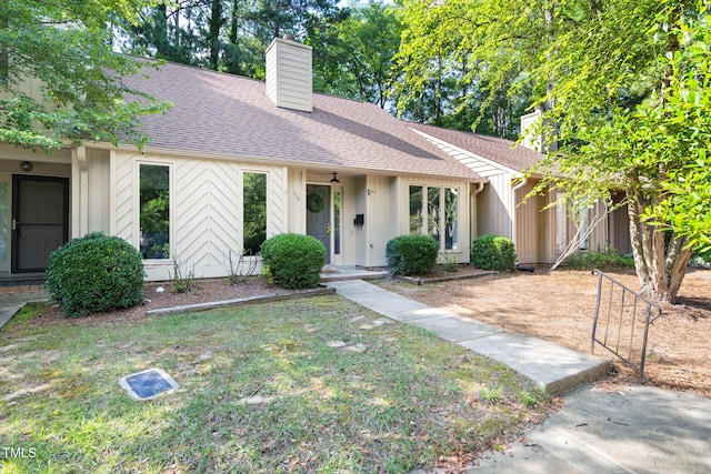 110 Mossbark Ln, Chapel Hill, NC 27514 - mid-century home featuring a chimney, a shingled roof, and a front lawn