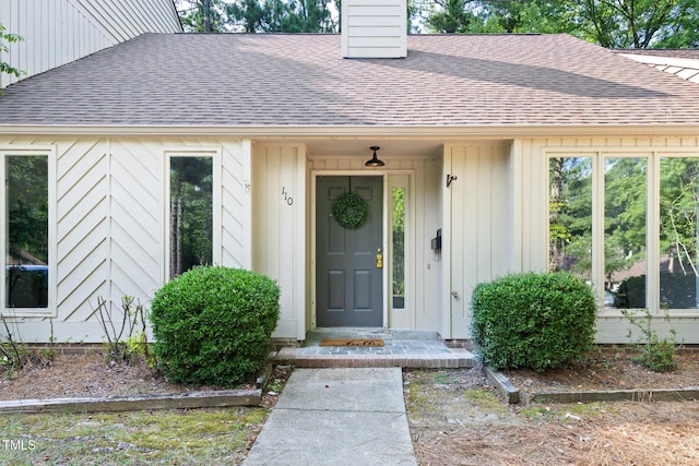 110 Mossbark Ln, Chapel Hill, NC 27514 - doorway to property featuring a shingled roof and a chimney