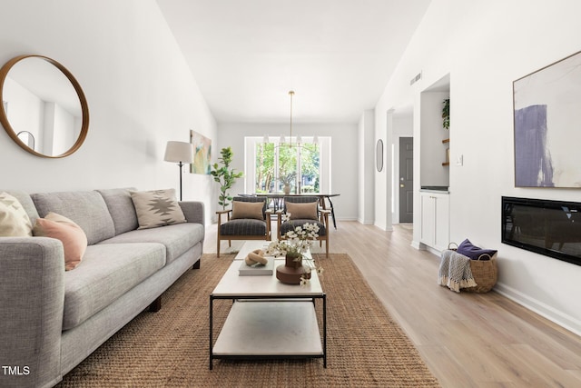 110 Mossbark Ln, Chapel Hill, NC 27514 - living area with light wood-type flooring and vaulted ceiling