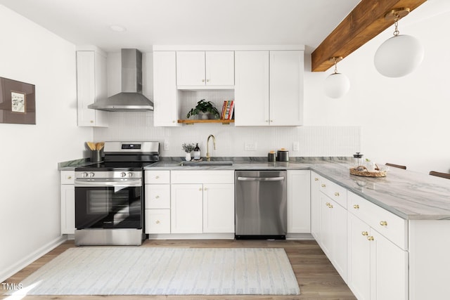 110 Mossbark Ln, Chapel Hill, NC 27514 - kitchen featuring stainless steel appliances, wall chimney range hood, a peninsula, light wood-style flooring, and white cabinetry