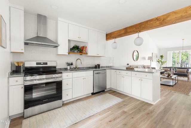 110 Mossbark Ln, Chapel Hill, NC 27514 - kitchen featuring wall chimney range hood, stainless steel appliances, open floor plan, a peninsula, and white cabinetry