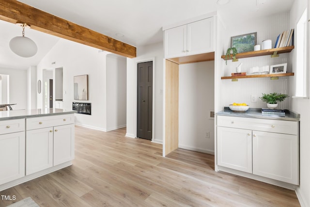 110 Mossbark Ln, Chapel Hill, NC 27514 - kitchen featuring light wood-type flooring, open shelves, beam ceiling, and white cabinets