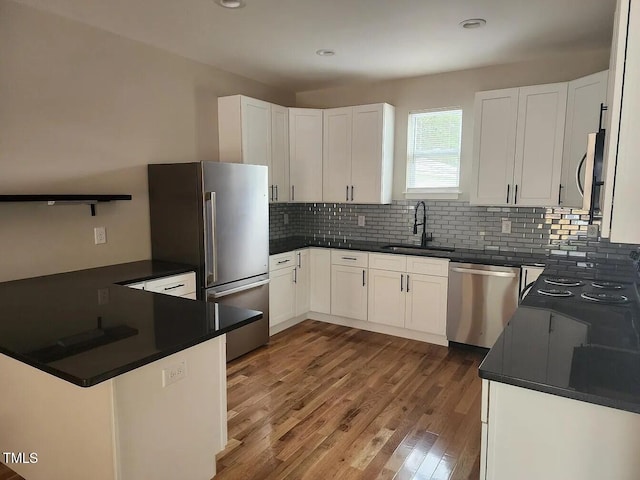 3241 Rowena, Durham, NC 27703 - kitchen with appliances with stainless steel finishes, dark countertops, decorative backsplash, and recessed lighting