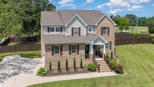 3082 Cascade Dr, Burlington, NC 27217 - view of front of home featuring board and batten siding, brick siding, and roof with shingles