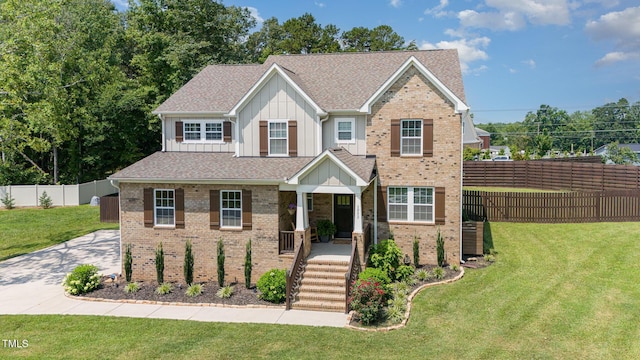 3082 Cascade Dr, Burlington, NC 27217 - view of front facade featuring board and batten siding, brick siding, roof with shingles, and covered porch