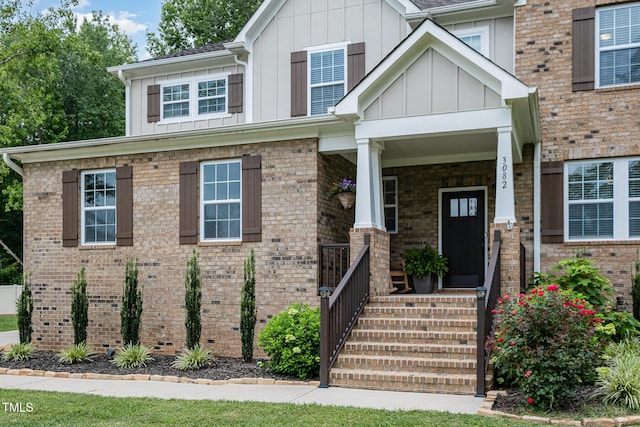 3082 Cascade Dr, Burlington, NC 27217 - craftsman-style house featuring board and batten siding, covered porch, and brick siding