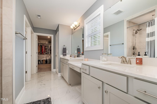 3082 Cascade Dr, Burlington, NC 27217 - full bathroom featuring a tile shower, two vanities, a spacious closet, and marble finish floors