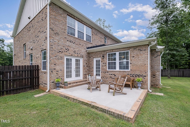 3082 Cascade Dr, Burlington, NC 27217 - rear view of house with board and batten siding, a patio area, brick siding, and french doors