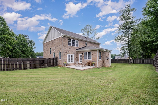 3082 Cascade Dr, Burlington, NC 27217 - rear view of house with brick siding, a fenced backyard, a patio, and french doors