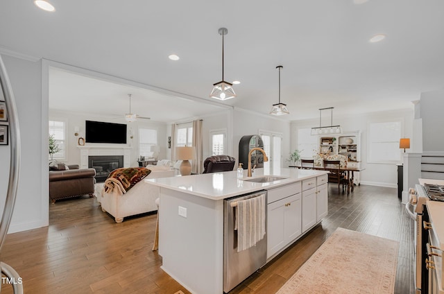 3082 Cascade Dr, Burlington, NC 27217 - kitchen with appliances with stainless steel finishes, a glass covered fireplace, ceiling fan, light countertops, and a center island with sink