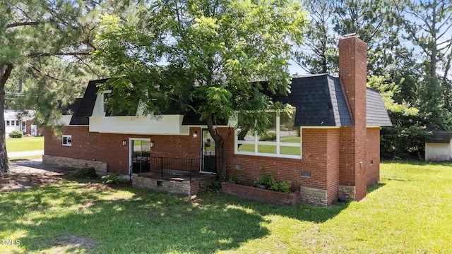 1617 Chase St, Rocky Mount, NC 27801 - view of front of property with a front yard, brick siding, a chimney, and roof with shingles