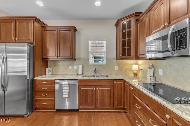 936 Blue Bird Ln, Wake Forest, NC 27587 - kitchen with stainless steel appliances, light wood finished floors, light stone counters, glass insert cabinets, and backsplash