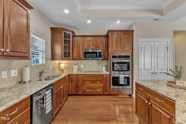 936 Blue Bird Ln, Wake Forest, NC 27587 - kitchen with appliances with stainless steel finishes, a tray ceiling, light wood-type flooring, light stone counters, and recessed lighting