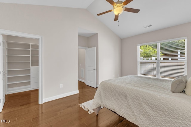 936 Blue Bird Ln, Wake Forest, NC 27587 - bedroom featuring a spacious closet, wood finished floors, vaulted ceiling, ceiling fan, and a closet