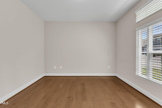 936 Blue Bird Ln, Wake Forest, NC 27587 - spare room featuring wood finished floors and plenty of natural light