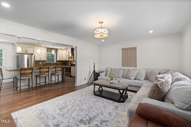 1319 Legend Rd, Raleigh, NC 27603 - living area featuring dark wood finished floors, recessed lighting, and ornamental molding