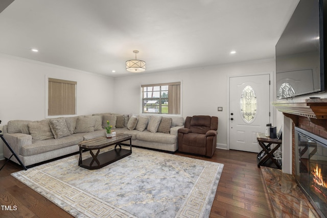 1319 Legend Rd, Raleigh, NC 27603 - living area with ornamental molding, a brick fireplace, dark wood-type flooring, and recessed lighting