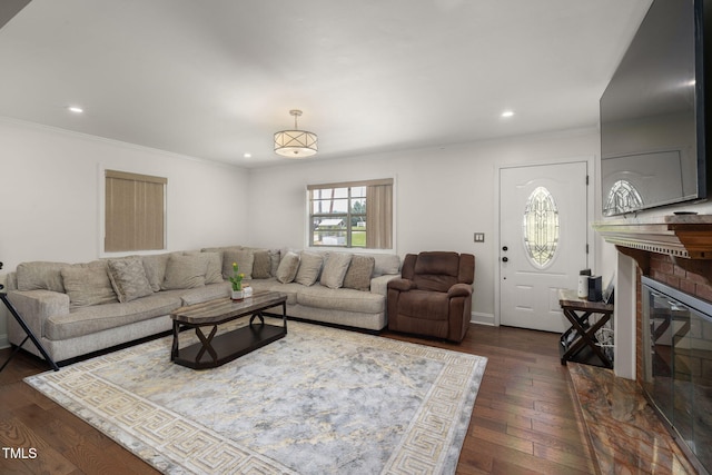 1319 Legend Rd, Raleigh, NC 27603 - living area with crown molding, dark wood finished floors, recessed lighting, and a brick fireplace