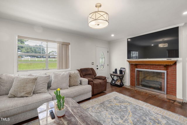 1319 Legend Rd, Raleigh, NC 27603 - living area featuring wood finished floors, ornamental molding, a fireplace, and recessed lighting