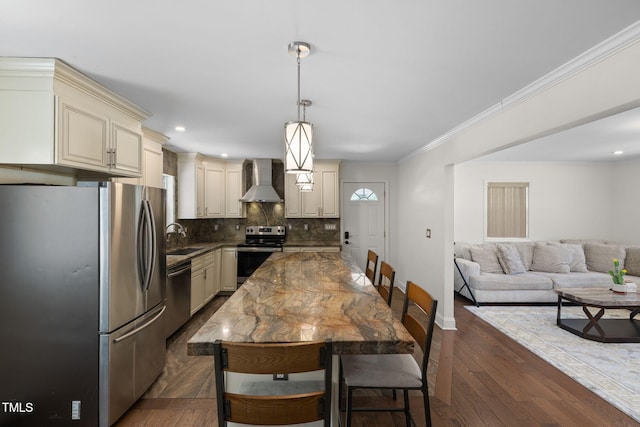 1319 Legend Rd, Raleigh, NC 27603 - kitchen with stainless steel appliances, cream cabinets, wall chimney exhaust hood, decorative backsplash, and open floor plan