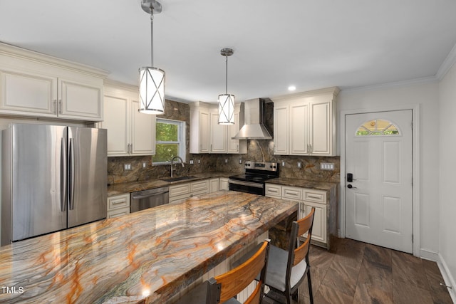 1319 Legend Rd, Raleigh, NC 27603 - kitchen with appliances with stainless steel finishes, wall chimney exhaust hood, tasteful backsplash, a breakfast bar area, and ornamental molding