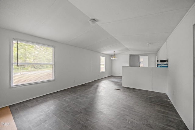 302 Allen Ave, Franklinton, NC 27525 - unfurnished living room with vaulted ceiling, a chandelier, and dark wood-type flooring