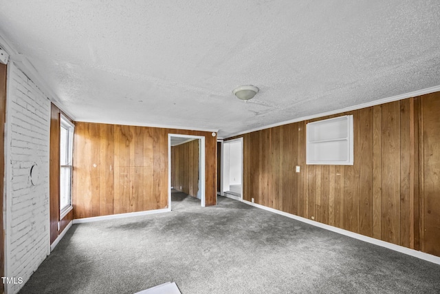302 Allen Ave, Franklinton, NC 27525 - unfurnished bedroom featuring a textured ceiling, wooden walls, carpet, and a baseboard radiator