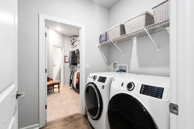 1066 Bingley Dr, Durham, NC 27703 - washroom featuring washer and clothes dryer and wood finished floors