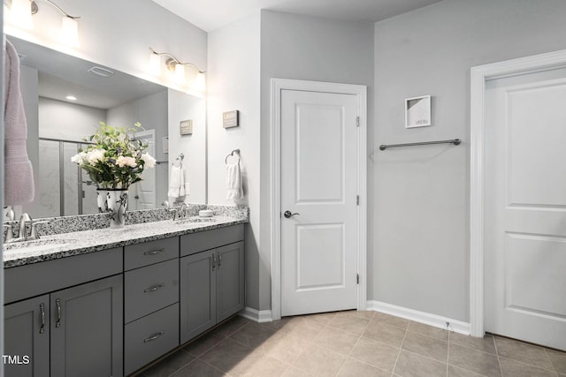 1066 Bingley Dr, Durham, NC 27703 - bathroom with double vanity, a stall shower, and tile patterned flooring