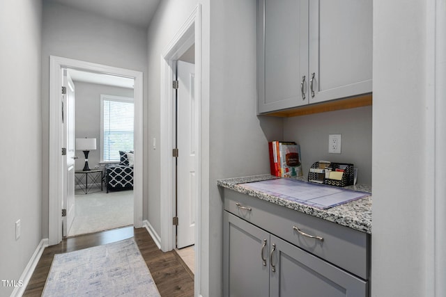 1066 Bingley Dr, Durham, NC 27703 - bar with dark wood-style floors and baseboards