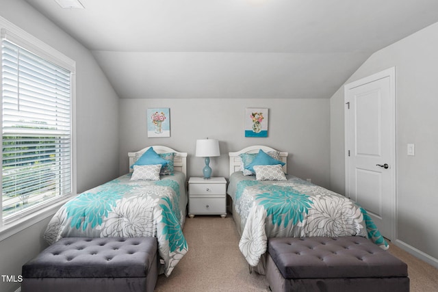 1066 Bingley Dr, Durham, NC 27703 - carpeted bedroom with lofted ceiling and multiple windows