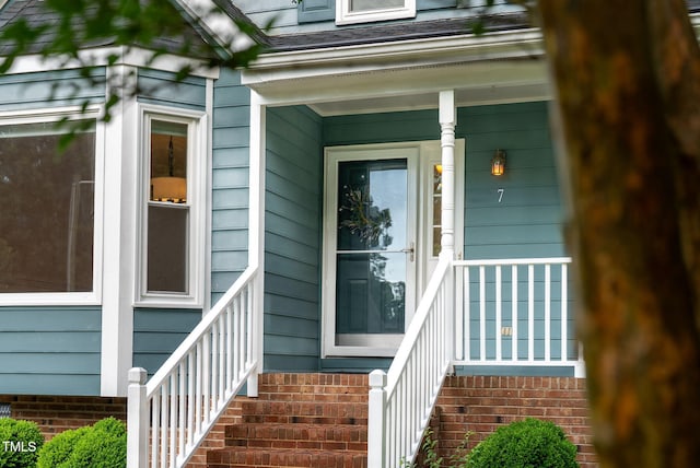 7 Nadeau Ct, Durham, NC 27704 - doorway to property with roof with shingles and covered porch