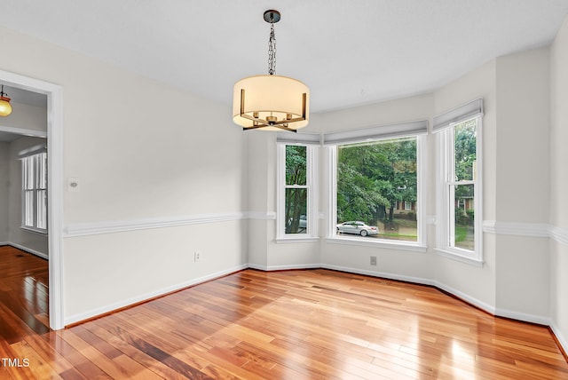 7 Nadeau Ct, Durham, NC 27704 - unfurnished room with wood-type flooring and a chandelier