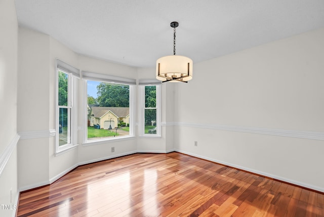7 Nadeau Ct, Durham, NC 27704 - unfurnished room with a chandelier and wood finished floors