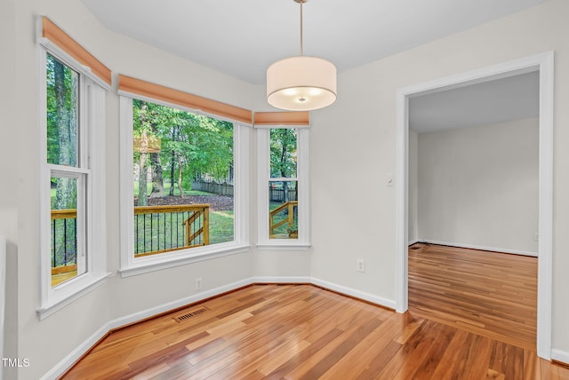 7 Nadeau Ct, Durham, NC 27704 - unfurnished dining area featuring wood finished floors and plenty of natural light