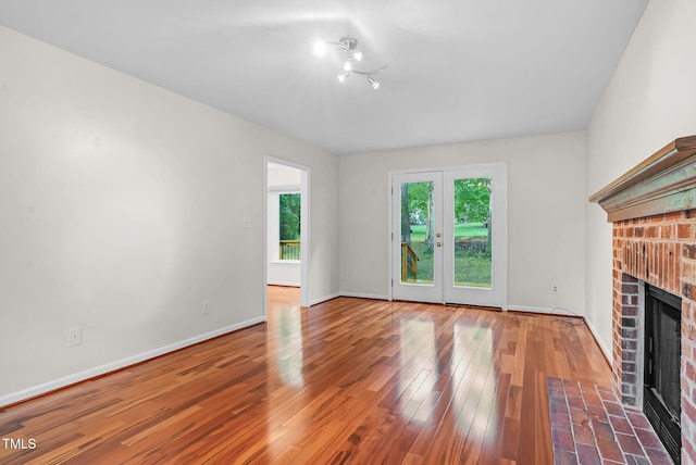 7 Nadeau Ct, Durham, NC 27704 - unfurnished living room featuring a fireplace and wood finished floors