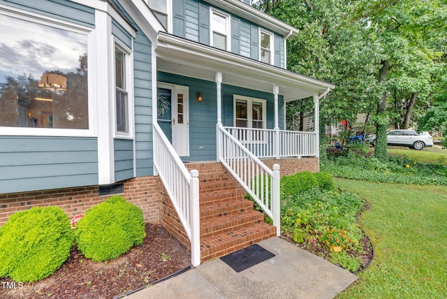 7 Nadeau Ct, Durham, NC 27704 - view of exterior entry featuring covered porch and a yard