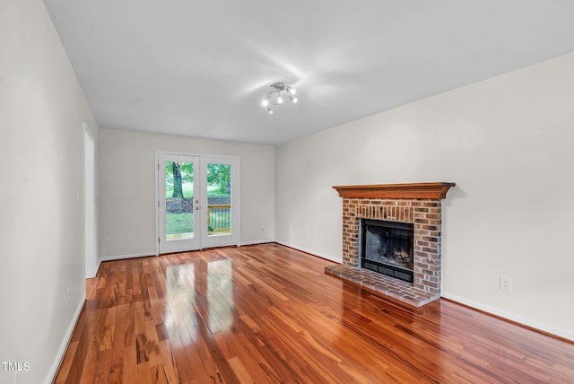 7 Nadeau Ct, Durham, NC 27704 - unfurnished living room with a fireplace and hardwood / wood-style flooring