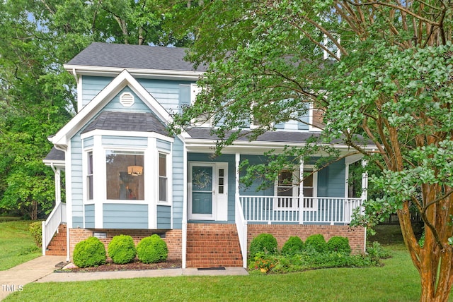 7 Nadeau Ct, Durham, NC 27704 - view of front facade featuring covered porch, stairway, a front lawn, and roof with shingles