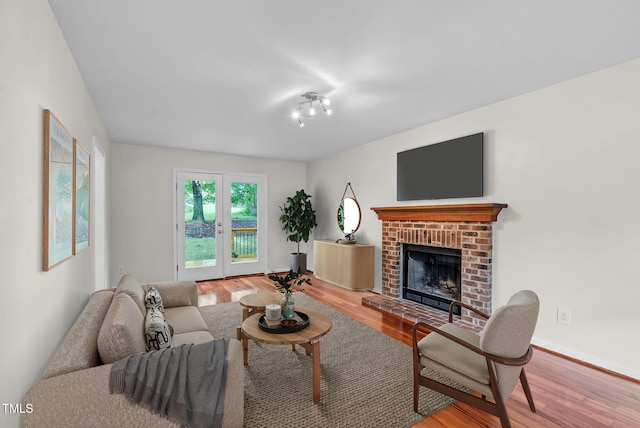 7 Nadeau Ct, Durham, NC 27704 - living room featuring wood finished floors and a brick fireplace
