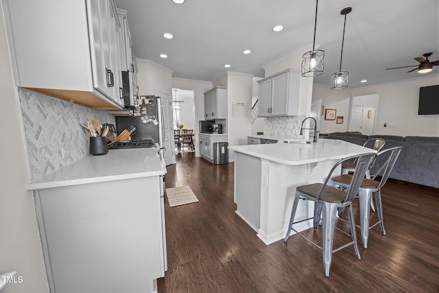 1304 Bromby Ave, Knightdale, NC 27545 - kitchen with open floor plan, recessed lighting, ornamental molding, a breakfast bar, and dark wood-type flooring
