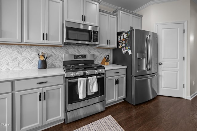 1304 Bromby Ave, Knightdale, NC 27545 - kitchen featuring appliances with stainless steel finishes, ornamental molding, gray cabinetry, decorative backsplash, and light countertops