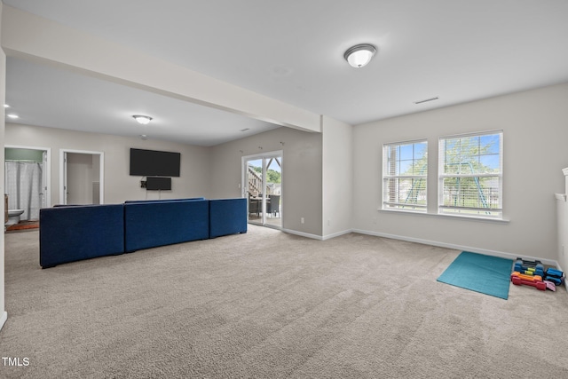 1304 Bromby Ave, Knightdale, NC 27545 - unfurnished living room with carpet flooring and baseboards